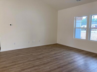 Spare room with visible vents, baseboards, and dar