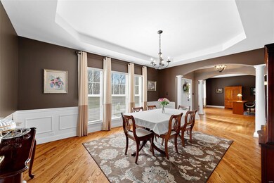 Spacious elegant dining room features coffered cei