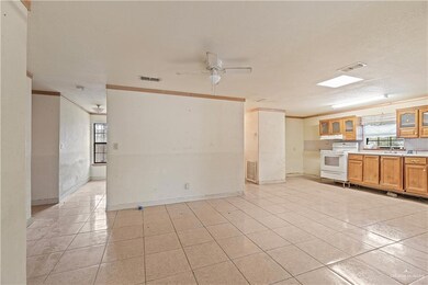 Kitchen featuring white range with electric stovetop, ceiling fan, decorative backsplash, and light tile patterned floors