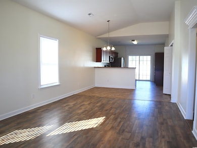 Interior space featuring lofted ceiling, dark wood