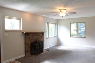 The living room boasts of a handsome stone firepla