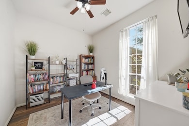 The study features a front-facing window that provides a lovely view and plenty of natural light. It boasts high ceilings and a ceiling fan with a light above, enhancing the room’s brightness and open feel. The space is enclosed by elegant French glass doors, with an additional set leading to a convenient storage closet. This versatile flex room offers endless possibilities — use it as a home office, library, playroom, or anything that fits your lifestyle.