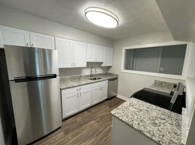 Kitchen featuring light stone countertops, stainle