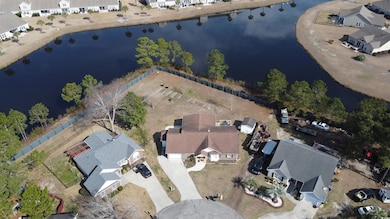 Aerial view featuring a water view and a residenti