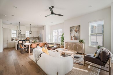 Living area featuring light wood-style floors, recessed lighting, and a ceiling fan