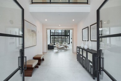 Double iron and glass front doors open into the do