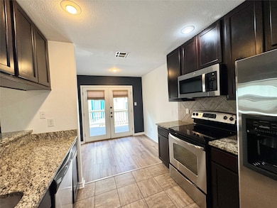 Kitchen featuring appliances with stainless steel