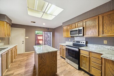 Sunny & bright island kitchen with granite counter
