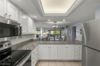 Kitchen with stainless steel appliances, a raised
