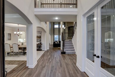 The front door opens to reveal a grand foyer with