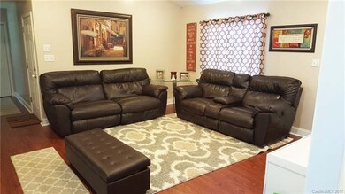 Wider view of great room with view of hallway lead