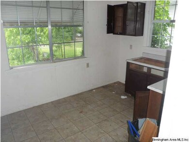 Kitchen looking out windows to backyard.