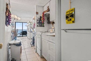 Kitchen with a textured ceiling, light countertops