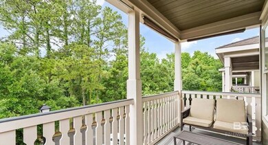 Balcony featuring view of wooded area