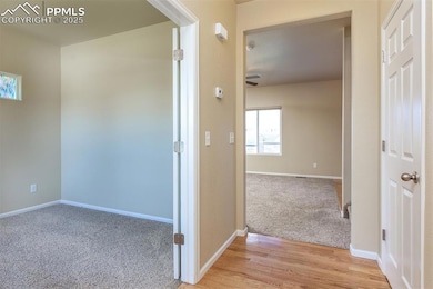 Hallway with light wood-style floors, light colore