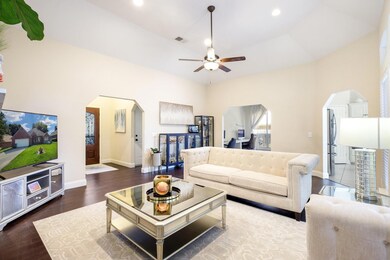 Living room featuring a high ceiling, dark hardwoo