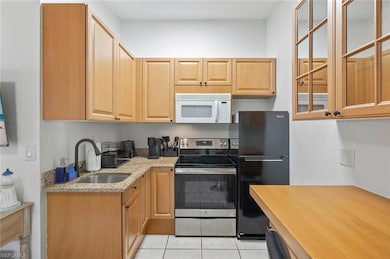 Kitchen featuring a sink, freestanding refrigerato