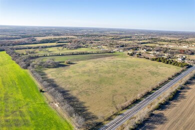 Birds eye view of property featuring a rural view
