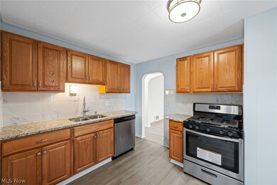 Kitchen featuring stainless steel appliances, light wood-type flooring, and double sink