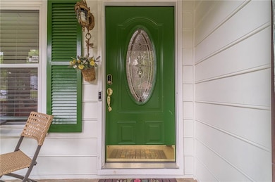 Entrance to property featuring covered porch