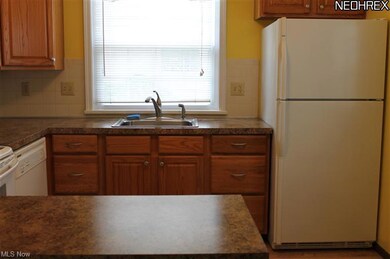 BEAUTIFUL UPDATED KITCHEN CABINETS, COUNTERTOP, SINK, FLOOR AND ALL APPLIANCES REMAIN !