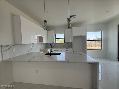 Kitchen featuring a sink, modern cabinets, white c