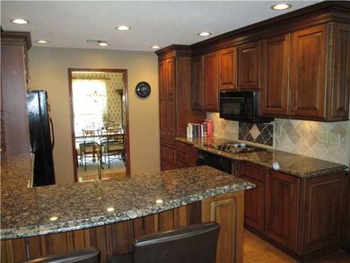 Gorgeous backsplash, breakfast bar, cooktop and ca