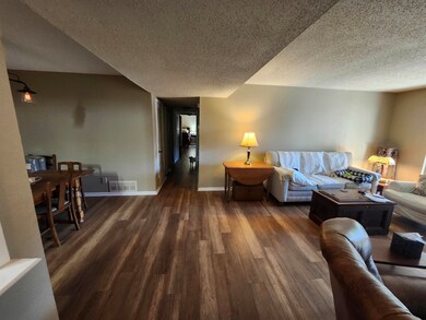 Living room featuring dark wood-style floors, visi