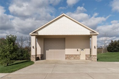 Outbuilding 32x60 ft. Water, gas, and electric.  Rough in for bathroom.  Exterior lighting on timers.  13'6