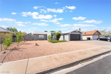 View of front facade featuring fence, driveway, an