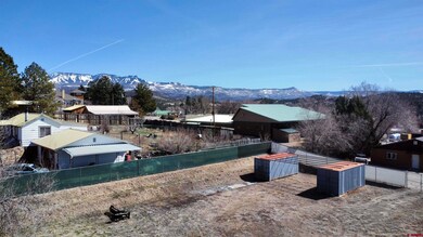 View of yard with a mountain view and fence