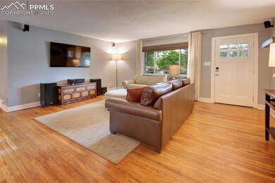 Living area with hardwood / wood-style flooring and baseboards