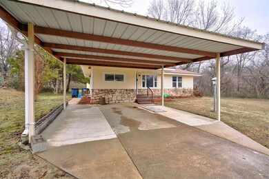 View of patio with a carport