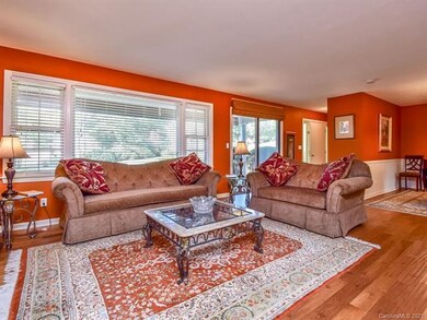 Beautiful living room featuring bamboo floors and lots of windows.