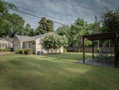Note the appealing pergola and the beautiful yard,