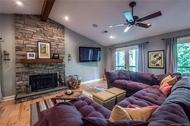Great Room with wood-burning stone fireplace. Wind