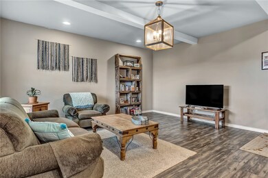 Living room featuring baseboards, dark luxury viny