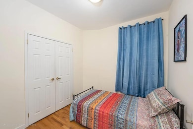Bedroom with wood finished floors
