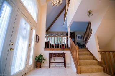 Beautiful foyer with lofted ceiling and travertine