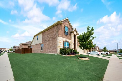 View of side of home featuring brick siding and stone siding