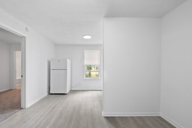 This photo shows a small, bright room with white w