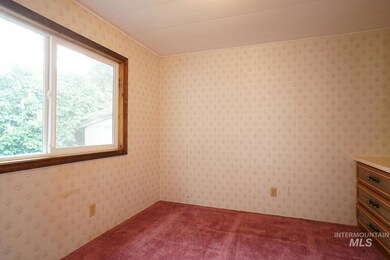 Empty room with dark colored carpet