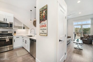 Kitchen with white cabinets, stainless steel appli