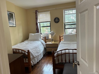 Bedroom with multiple windows and hardwood / wood-style flooring