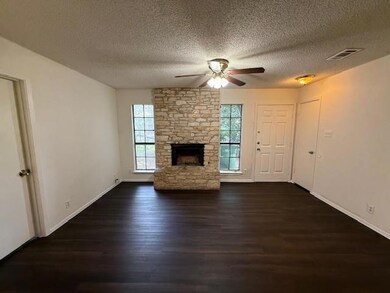 Unfurnished living room with a ceiling fan, dark 