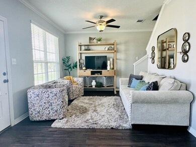 Living room with ornamental molding, wood finished