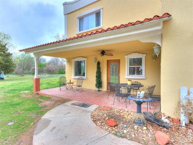 Entrance to property with a lawn, a patio, and ceiling fan