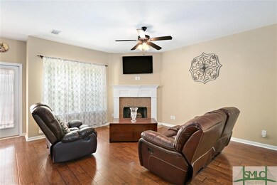 THE GREAT ROOM FEATURES A GAS FIREPLACE, WOOD FLOO