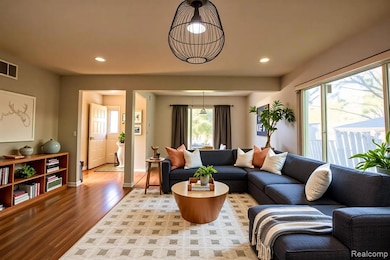 Living room featuring light wood-type flooring and recessed lighting