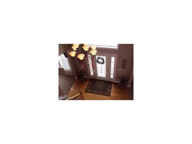 Two story foyer with Palladium window and hard woo